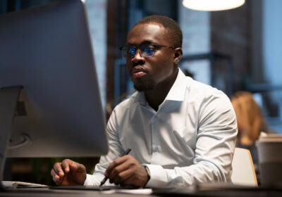 black-man-working-with-computer_23-2149370567