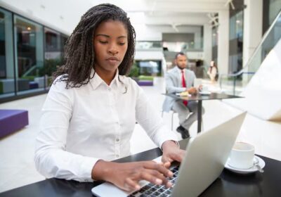 focused-female-manager-working-laptop_74855-2783