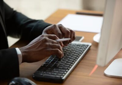 typing-text-close-up-african-american-entrepreneur-businessman-working-concentrated-office-looks-serios-busy-wearing-classic-suit_155003-39332-1