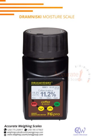 Dramniski grain moisture meters with a jug in store Kampala